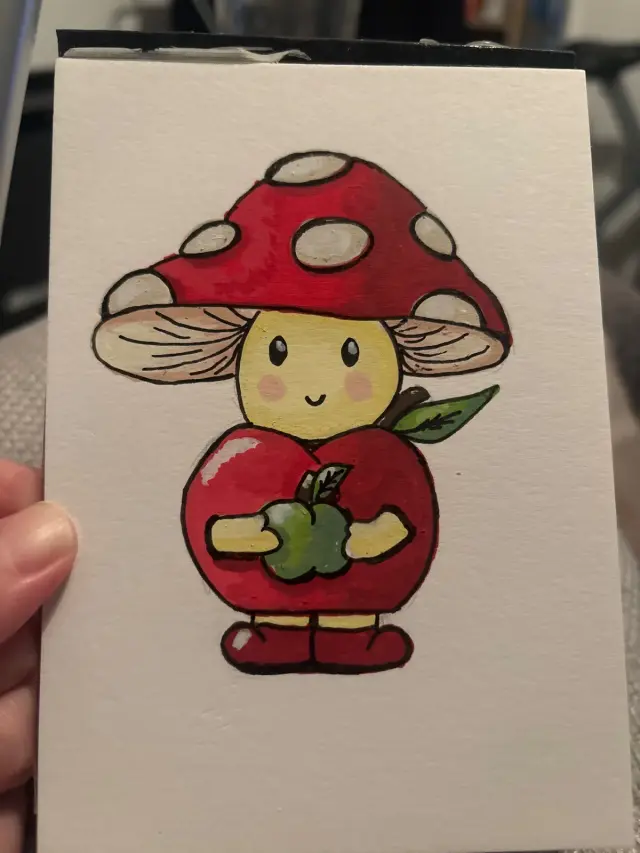 mushroom dressed as an apple holding an apple